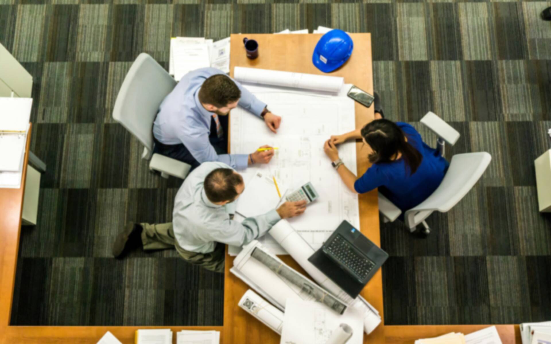 Top view of a group of architects working on designs on a table top