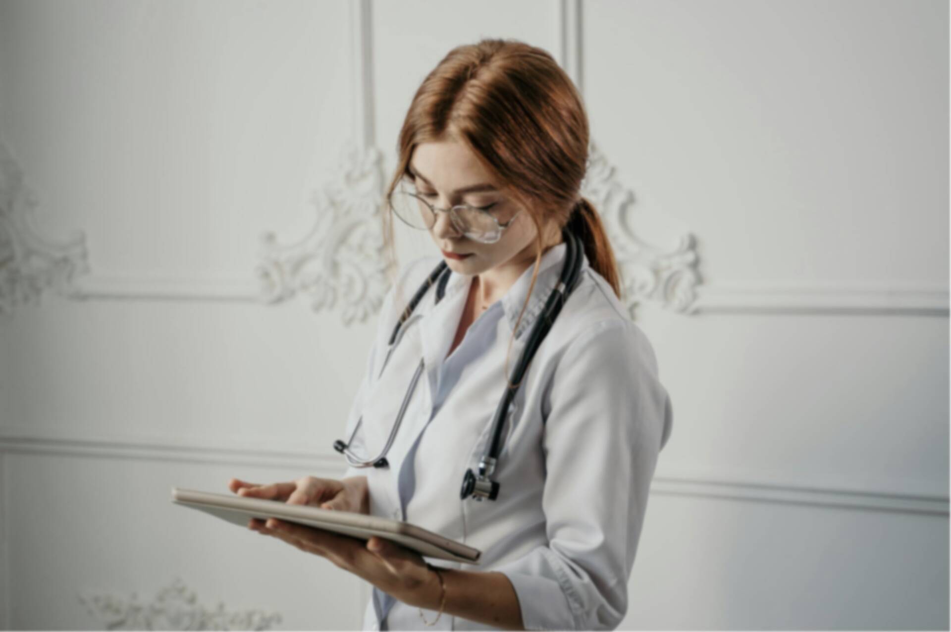 Doctor checking schedule on EvoKomms on a tablet | EvoKomms