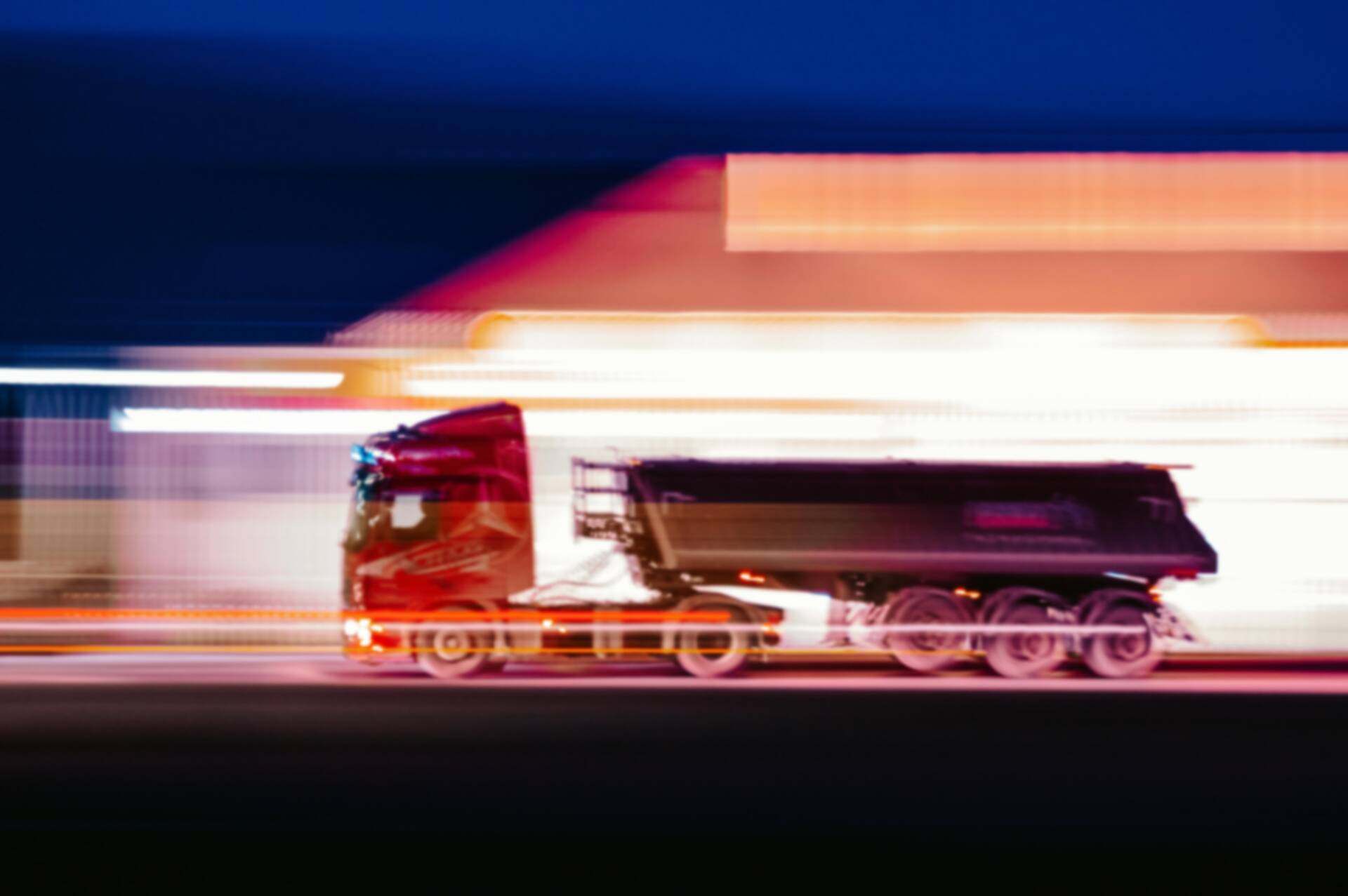 A slow shutter exposure of a long hauler truck driving on a highway | EvoKomms