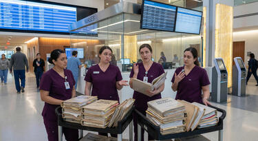 Nurses going through patient records and arguing about them | EvoKomms