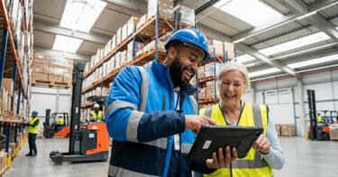 Warehouse manager showing frontline employee the EvoKomms Employee Engagement App Dashboard on a tablet